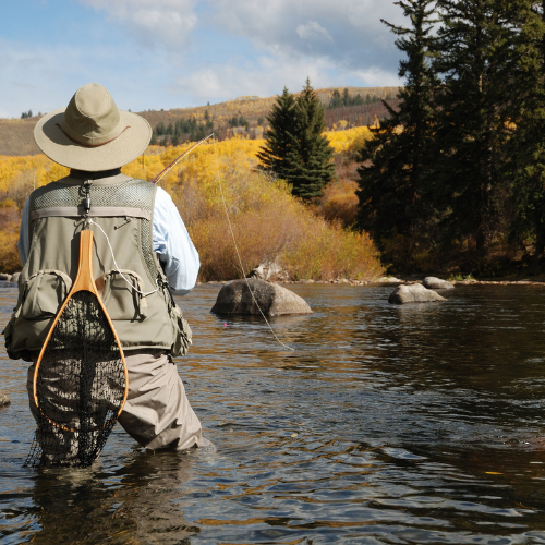 Man fishing while standing in water